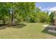 Spacious backyard with lush green grass and mature trees offers ample outdoor space at 4432 Logwood Drive, Ladson, SC 29456