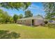 Well-maintained backyard featuring a brick home exterior, lush lawn, and mature trees at 4432 Logwood Drive, Ladson, SC 29456