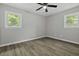 This bedroom features hardwood floors, a ceiling fan, and two windows at 4432 Logwood Drive, Ladson, SC 29456
