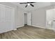 This bedroom features a ceiling fan, hardwood floors, a closet, and an attached bathroom at 4432 Logwood Drive, Ladson, SC 29456