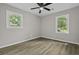 This bedroom includes hardwood floors, a ceiling fan, and two windows at 4432 Logwood Drive, Ladson, SC 29456