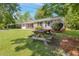 Charming home with lush front lawn and mature trees, creating a serene and inviting outdoor space at 4432 Logwood Drive, Ladson, SC 29456