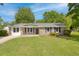 Charming brick home with black shutters and a well-manicured front yard with a lovely green lawn at 4432 Logwood Drive, Ladson, SC 29456
