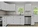Close up of kitchen featuring stainless steel dishwasher, white cabinets, and a granite countertop at 4432 Logwood Drive, Ladson, SC 29456