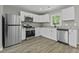 Modern kitchen featuring stainless steel appliances, granite countertops, and white cabinetry at 4432 Logwood Drive, Ladson, SC 29456