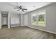 Open living room with wood floors, large windows, and a mudroom-style coat rack at 4432 Logwood Drive, Ladson, SC 29456