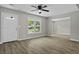 Bright living room featuring wood floors, ceiling fan, and a large window at 4432 Logwood Drive, Ladson, SC 29456