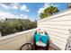 Cozy balcony with seating and views of lush trees and blue sky at 4577 Summey St, North Charleston, SC 29405