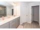 Modern bathroom with double vanity, quartz counters, and gray tiled flooring at 4577 Summey St, North Charleston, SC 29405