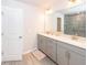 Bright bathroom with double vanity and modern fixtures, tiled shower in background at 4577 Summey St, North Charleston, SC 29405