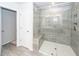 Well-lit bathroom featuring a glass enclosed shower with bench and neutral tiling at 4577 Summey St, North Charleston, SC 29405