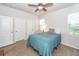 Well-lit bedroom featuring neutral walls, a ceiling fan, carpet, and two closets at 4577 Summey St, North Charleston, SC 29405