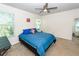 Bedroom featuring a ceiling fan, carpet, and a bed with blue bedding and decorative pillows at 4577 Summey St, North Charleston, SC 29405