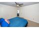 Bedroom with a ceiling fan, carpet, and a bed with blue bedding and decorative pillows at 4577 Summey St, North Charleston, SC 29405