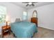 Cozy bedroom with a simple decor, comfortable bed, and a charming dresser near the window at 4577 Summey St, North Charleston, SC 29405