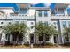 Modern townhome featuring light gray siding, dark trim windows and landscaping at 4577 Summey St, North Charleston, SC 29405