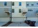 Rear exterior of townhome featuring multiple units and two-car garages at 4577 Summey St, North Charleston, SC 29405