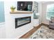 Modern electric fireplace with a white brick surround and wooden mantel enhances this cozy living space at 4577 Summey St, North Charleston, SC 29405