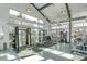 Modern gym with high ceilings and lots of windows, featuring weightlifting and exercise equipment at 4577 Summey St, North Charleston, SC 29405