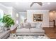 Bright living room with ample seating, a decorative mirror, and a view towards the staircase and dining area at 4577 Summey St, North Charleston, SC 29405