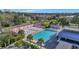 Aerial view of a community pool with abundant lounge chairs and surrounding trees in a park like setting at 4577 Summey St, North Charleston, SC 29405