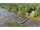 Breathtaking aerial view showcasing the serene waterfront property, long docks, and lush surroundings at 478 Commonwealth Rd, Mount Pleasant, SC 29466