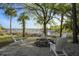 Backyard patio with stone fire pit and adirondack chairs near waterfront at 478 Commonwealth Rd, Mount Pleasant, SC 29466