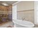 Bathroom featuring a glass enclosed shower and soaking tub at 478 Commonwealth Rd, Mount Pleasant, SC 29466