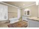 Elegant bathroom features a soaking tub, shuttered window, and dual sink vanity with granite counters at 478 Commonwealth Rd, Mount Pleasant, SC 29466