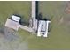 Aerial view of a private boat dock with a boat, extending into the waterway at 478 Commonwealth Rd, Mount Pleasant, SC 29466