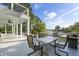 Covered deck offering river views with a dining table, chairs, and a grill at 478 Commonwealth Rd, Mount Pleasant, SC 29466