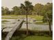 Beautiful view of the waterway and a private wooden dock extending into the tranquil water at 478 Commonwealth Rd, Mount Pleasant, SC 29466