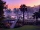 Tranquil scene of a dock in a misty waterway at sunrise, perfect for relaxation and enjoying nature at 478 Commonwealth Rd, Mount Pleasant, SC 29466