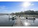 Wide view of a private dock with boat lift on a sunny day at 478 Commonwealth Rd, Mount Pleasant, SC 29466