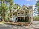 Two-story home featuring a welcoming porch, white railings and ample space for outdoor relaxation at 478 Commonwealth Rd, Mount Pleasant, SC 29466