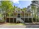 Charming coastal home with a spacious porch, landscaped yard, and inviting staircase at 478 Commonwealth Rd, Mount Pleasant, SC 29466