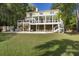 Stunning home exterior featuring a large pool, multiple decks, and a lush backyard surrounded by mature trees at 478 Commonwealth Rd, Mount Pleasant, SC 29466