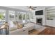 Cozy living room with a stylish white sectional, fireplace, and scenic views of the outdoors at 478 Commonwealth Rd, Mount Pleasant, SC 29466