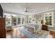 Bright main bedroom features hardwood floors, a ceiling fan, and sliding glass doors to a patio at 478 Commonwealth Rd, Mount Pleasant, SC 29466