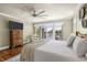 Bright main bedroom features hardwood floors, a ceiling fan, and views of the water at 478 Commonwealth Rd, Mount Pleasant, SC 29466