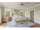 Bright main bedroom features hardwood floors, a ceiling fan, and doorway to the bathroom at 478 Commonwealth Rd, Mount Pleasant, SC 29466