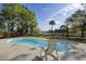 View of the in-ground pool, landscaped yard, and waterfront at 478 Commonwealth Rd, Mount Pleasant, SC 29466