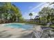 Sparkling pool surrounded by a spacious patio with comfortable seating and lush green landscaping at 478 Commonwealth Rd, Mount Pleasant, SC 29466