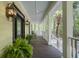 Inviting porch featuring classic lighting, comfortable seating, and lush greenery accents at 478 Commonwealth Rd, Mount Pleasant, SC 29466