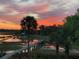 Stunning sunset view of a tranquil waterway and private docks, enhancing the home's waterfront appeal at 478 Commonwealth Rd, Mount Pleasant, SC 29466