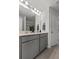 Bathroom with double vanity sinks, granite countertops, and gray painted cabinets at 484 Trotters Ln, Moncks Corner, SC 29461