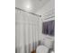 Bathroom featuring shower with curtain, toilet, and decorative towels at 484 Trotters Ln, Moncks Corner, SC 29461