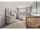 Bedroom featuring crib, chair, dresser, and natural light from window at 484 Trotters Ln, Moncks Corner, SC 29461