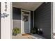 Inviting front porch with a wreath, potted plants, and a 'Welcome Home' doormat at 484 Trotters Ln, Moncks Corner, SC 29461