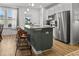 Kitchen featuring a gray island with seating, granite countertops, and stainless steel appliances at 484 Trotters Ln, Moncks Corner, SC 29461